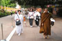 Venerable Phrakhru Sitthiwarakhom and Buddhist pilgrims walking outside the monastery.